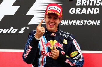 NORTHAMPTON, UNITED KINGDOM - JUNE 21:  Sebastian Vettel of Germany and Red Bull Racing celebrates on the podium after winning the British Formula One Grand Prix at Silverstone on June 21, 2009 in Northampton, England.  (Photo by Clive Mason/Getty Images)