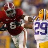 BATON ROUGE, LA - NOVEMBER 08:  Julio Jones #8 of the Alabama Crimson Tide avoids a tackle by Chris Hawkins #29 of the Louisiana State University Tigers  on November 11, 2008 at Tiger Stadium in Baton Rouge, Louisiana. The Tide defeated the Tigers 27-21 i
