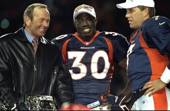 17 Jan 1999:  Terrell Davis #30 of the Denver Broncos stands with Broncos owner Pat Bowlen (L) and John Elway #7 after winning the AFC Championship Game against the New York Jets at Mile High Stadium in Denver, Colorado. The Broncos defeated the Jets 23-1