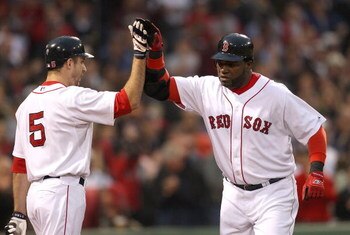 BOSTON - JUNE 11:  David Ortiz #34 of the Boston Red Sox hits a home run and celebrates with teammate Rocco Baldelli against the New York Yankees at Fenway Park on June 11, 2009 in Boston, Massachusetts.  (Photo by Jim Rogash/Getty Images)