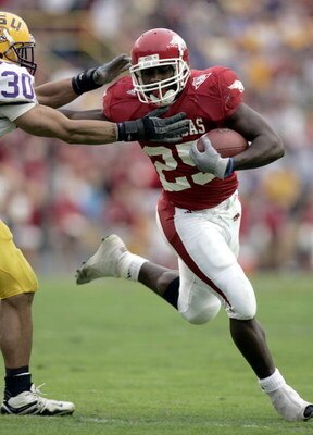 BATON ROUGE, LA - NOVEMBER 25:  Felix Jones #25 of the Arkansas Razorbacks rushes against LaRon Landry #30 of the LSU Tigers on November 25, 2005 at Tiger Stadium in Baton Rouge, Louisiana. LSU defeated Arkansas 19-17.  (Photo by Chris Graythen/Getty Imag