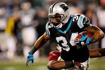 CHARLOTTE, NC - JANUARY 10:  DeAngelo Williams #34 of the Carolina Panthers runs against Gerald Hayes #54 of the Arizona Cardinals during the NFC Divisional Playoff Game on January 10, 2009 at Bank of America Stadium in Charlotte, North Carolina.  (Photo 
