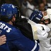 TORONTO - MARCH 11:  Gary Roberts #7 of the Toronto Maple Leafs trades gloves in the face with Kelly Buchberger #7 of the Pittsburgh Penguins March 11, 2004 at Air Canada Centre in Toronto, Ontario, Canada. The Penguins beat the Leafs 3-2.  (Photo By Dave