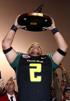 SAN DIEGO, CA - DECEMBER 30:   Quarterback Jeremiah Masoli #2 of the University of Oregon Ducks holds the Offensive Player of the Game trophy after beating the Oklahoma State University Cowboys in the Pacific Life Holiday Bowl at Qualcomm Stadium on Decem