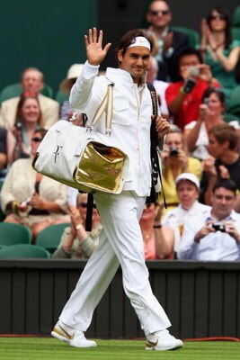 WIMBLEDON, ENGLAND - JUNE 22:  Roger Federer of Switzerland waves to the crowd prior to the men's singles first round match against Yen-Hsun Lu of Chinese Taipei on Day One of the Wimbledon Lawn Tennis Championships at the All England Lawn Tennis and Croq
