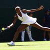 WIMBLEDON, ENGLAND - JUNE 23:  Venus Williams of USA stretches to play a forehand during the women's singles first round match against Stefanie Voegele of Switzerland on Day Two of the Wimbledon Lawn Tennis Championships at the All England Lawn Tennis and
