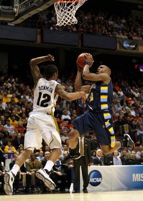 BOISE, ID - MARCH 22:  Guard Jerel McNeal #22 of the Marquette Golden Eagles drives the ball to the hoop against the Missouri Tigers during the second round of the NCAA Division I Men's Basketball Tournament at the Taco Bell Arena on March 22, 2009 in Boi