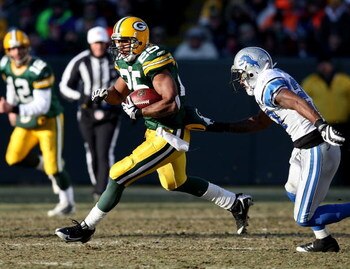 GREEN BAY, WI - DECEMBER 28: Ryan Grant #25 of the Green Bay Packers runs past Daniel Bullocks #27 of the Detroit Lions on December 28, 2008 at Lambeau Field in Green Bay, Wisconsin. The Packers defeated the Lions 31-21. (Photo by Jonathan Daniel/Getty Im