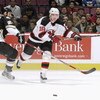 EAST RUTHERFORD, NJ - DECEMBER 6:  Center Sergei Brylin #18 of the New Jersey Devils chases down the puck while being defended by left wing Steve McKenna #23 of the Pittsburgh Penguins at Continental Airlines Arena on December 6, 2002 in East Rutherford, 