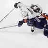 UNIONDALE, NY - JANUARY 26:  Joel Bouchard #4 of the New York Islanders reaches for the puck against Tomas Surovy #43 of the Pittsburgh Penguins during their NHL game on January 26, 2006 at Nassau Coliseum in Uniondale, New York. The Isles defeated the Pe