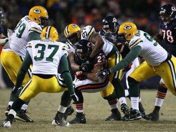 CHICAGO - DECEMBER 22: Matt Forte #22 of the Chicago Bears is gang-tackled by Johnny Jolly #97, Michael Montgomery #96, Ryan Pickett #79 and Aaron Rouse #37 of the Green Bay Packers on December 22, 2008 at Soldier Field in Chicago, Illinois. The Bears def
