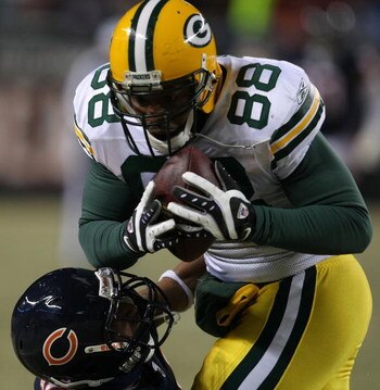 CHICAGO - DECEMBER 22: Jermichael Finley #88 of the Green Bay Packers catches a pass as Kevin Payne #44 of the Chicago Bears falls trying to make the tackle on December 22, 2008 at Soldier Field in Chicago, Illinois. The Bears defeated the Packers 20-17 i