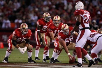 SAN FRANCISCO - SEPTEMBER 10:  Eric Heitmann #66 and Justin Smiley #65 wait on the offensive line as quarterback Alex Smith #11 of the San Francisco 49ers calls a play during an NFL game against the Arizona Cardinals on September 10, 2007 at Monster Park 