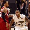 WINSTON-SALEM, NC - FEBRUARY 26:  Brandon Costner #33 of the North Carolina State Wolfpack can only watch as James Johnson #23 of the Wake Forest Demon Deacons celebrates after a dunk giving the Demon Deacons a 85-78 victory at Lawrence Joel Coliseum on F