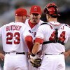 ANAHEIM, CA - APRIL 22:  Pitcher Joe Sauders #51 (C) of the Los Angeles Angels reacts as he get a visit from pitching coach Mike Butcher #23  while catcher Mike Napoli #44 loooks on after Saunders gave up a run to the Detroit Tigers during the first innin