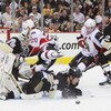 PITTSBURGH - APRIL 11: Goaltender Marc-Andre Fleury #29 of the Pittsburgh Penguins keeps his eyes on the puck as Brooks Orpik #44 of the Penguins slides into Fleury and Antoine Vermette #20 of the Ottawa Senators leaps in front of Fleury during game two o