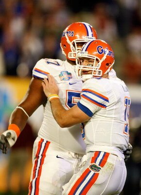 MIAMI - JANUARY 08:  Tim Tebow #15 (R) and Carl Johnson #57 of the Florida Gators celebrate after Tebow threw a 20-yard touchdown pass to Louis Murphy #9 in the second quarter against the Oklahoma Sooners during the FedEx BCS National Championship game at