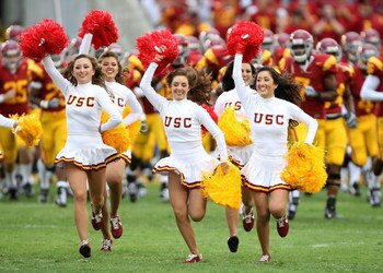 LOS ANGELES - SEPTEMBER 22:  Cheerleaders run onto the field ahead of the USC Trojans before the game with the Washington State Cougars on September 22, 2007 at the Los Angeles Coliseum in Los Angeles, California.  USC won 47-14. (Photo by Stephen Dunn/Ge