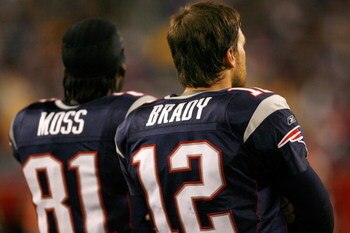 FOXBOROUGH, MA - DECEMBER 23: Randy Moss #81 and Tom Brady #12 of the New England Patriots stand on the sideline against the Miami Dolphins at Gillette Stadium on December 23, 2007 in Foxborough, Massachusetts. Patriots won 28-7. (Photo by Jim Rogash/Gett
