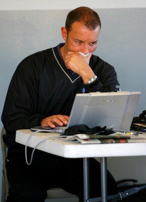 DAYTONA BEACH, FL - JANUARY 09: Chad Knauss, crew chief for the #48 Lowes Chevrolet driven by Jimmie Johnson working on his laptop in the garage during NASCAR testing at Daytona International Speedway on January 9, 2008 in Daytona Beach, Florida.  (Photo 
