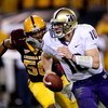 TEMPE, AZ - OCTOBER 13:  Quarterback Jake Locker #10 of the Washington Huskies runs away from the pursuit of linebacker Dexter Davis #58 of the Arizona State Sun Devils on October 13, 2007 at Sun Devil Stadium in Tempe, Arizona.  Arizona State won 44-20. 