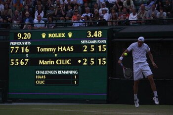 WIMBLEDON, ENGLAND - JUNE 26:  Tommy Haas of Germany plays a backhand as the light darkens during the men's singles third round match against Marin Cilic of Croatia on Day Five of the Wimbledon Lawn Tennis Championships at the All England Lawn Tennis and 