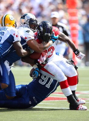 HONOLULU, HI - FEBRUARY 08: Fullback Le'Ron McClain #33 of the AFC All-Stars Baltimore Ravens gets gang tackled by NFC All-Stars Justin Tuck #91 of the New York Giants, Julius Peppers #90 of the Carolina Panthers, and Nick Collins #36 of the Green Bay Pac