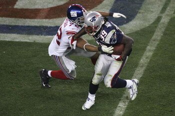 GLENDALE, AZ - FEBRUARY 03:  Running back Laurence Maroney #39 of the New England Patriots runs the ball as he is tackled by Osi Umenyiora #72 of the New York Giants during Super Bowl XLII on February 3, 2008 at the University of Phoenix Stadium in Glenda