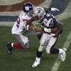 GLENDALE, AZ - FEBRUARY 03:  Running back Laurence Maroney #39 of the New England Patriots runs the ball as he is tackled by Osi Umenyiora #72 of the New York Giants during Super Bowl XLII on February 3, 2008 at the University of Phoenix Stadium in Glenda