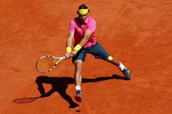 PARIS - MAY 29:  Rafael Nadal of Spain hits a backhand during his Men's Singles Third Round match against Lleyton Hewitt of Australia on day six of the French Open at Roland Garros on May 29, 2009 in Paris, France.  (Photo by Ryan Pierse/Getty Images)