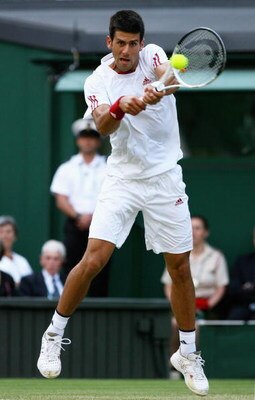 WIMBLEDON, ENGLAND - JUNE 26:  Novak Djokovic of Serbia plays a backhand during the men's singles third round match against Mardy Fish of USA on Day Five of the Wimbledon Lawn Tennis Championships at the All England Lawn Tennis and Croquet Club on June 26