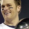 Tom Brady holds the Vince Lombardi Trophy as he stands on the podium after The New England Patriots defeated The Philadelphia Eagles in Super Bowl XXXIX at Alltel Staduim in Jacksonville, Florida.  (Photo by Al Messerschmidt/Getty Images)