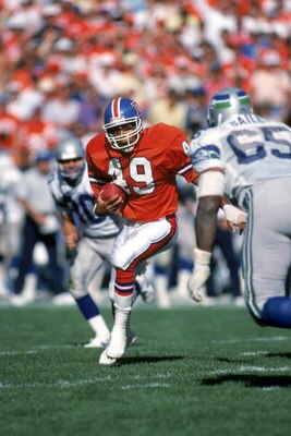 DENVER - SEPTEMBER 13:  Safety Dennis Smith #49 of the Denver Broncos runs back an interception during a game against the Seattle Seahawks at Mile High Stadium on September 13, 1987 in Denver, Colorado.  The Seahawks won 17-10.  (Photo by George Rose/Gett