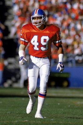 DENVER - NOVEMBER 5:  Dennis Smith #49 of the Denver Broncos walks on the field during a NFL game against the Pittsburgh Steelers at Mile High Stadium on November 5, 1989 in Denver, Colorado.  The Broncos defeated the Steelers 34-7.  (Photo by Tim DeFrisc