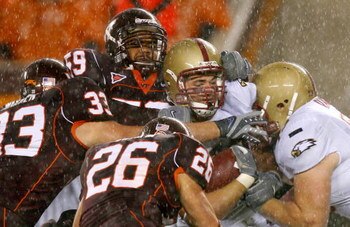 BLACKSBURG, VA - OCTOBER 25:  Offensive tackle Clif Ramsey #73 pushes as tight end Ryan Purvis #80 of the Boston College Eagles drives into defenders Brett Warren #33, Barry Booker #59 and Cody Grimm #26 of the Virginia Tech Hokies during the first half a