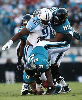 JACKSONVILLE, FL - NOVEMBER 16: Quarterback David Garrard #9 of the Jacksonville Jaguars fumbles as he is sacked by defensive tackle Albert Haynesworth #92 of the Tennessee Titans while he is blocked by offensive lineman Khalif Barnes #69 at Jacksonville 