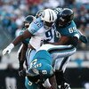 JACKSONVILLE, FL - NOVEMBER 16: Quarterback David Garrard #9 of the Jacksonville Jaguars fumbles as he is sacked by defensive tackle Albert Haynesworth #92 of the Tennessee Titans while he is blocked by offensive lineman Khalif Barnes #69 at Jacksonville 