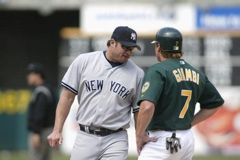 OAKLAND-APRIL 25: Jason Giambi #25 of the New York Yankees chats with brother Jeremy Giambi #7 of the Oakland A's during the game at Network Associates Coliseum in Oakland, California on April 25, 2002. The A's won 6-2. (Photo by Jed Jacobsohn/Getty Image