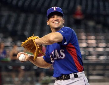 PHOENIX - JUNE 23:  Omar Vizquel #13 of the Texas Rangers warms up before the major league baseball game against the Arizona Diamondbacks at Chase Field on June 23, 2009 in Phoenix, Arizona. The Diamondbacks defeated the Rangers 8-2.  (Photo by Christian 