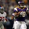 MINNEAPOLIS - DECEMBER 28:  Adrian Peterson #28 of the Minnesota Vikings carries the ball in for a touchdown as James Butler #37 of the New York Giants defends on December 28, 2008 at the Hubert H. Humphrey Metrodome in Minneapolis, Minnesota. (Photo by E