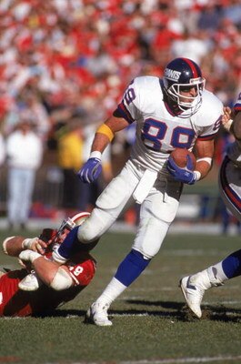SAN FRANCISCO - JANUARY 20:  Tight end Mark Bavaro #89 of the New York Giants tries to get away from the grasps of linebacker Keith DeLong #59 of the San Francisco 49ers in the 1990 NFC Championship game at Candlestick Park on January 20, 1991 in San Fran