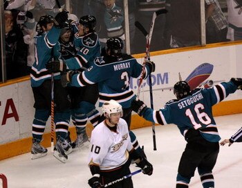 SAN JOSE, CA - APRIL 25:  Patrick Marleau #12 of the San Jose Sharks is mobbed by Joe Thornton #19, Christian Ernhoff #10 Douglas Murray #3, and Devin Setoguchi #16 after Marleau scored the game winning goal in overtime as Corey Perry #10 of the Anaheim D