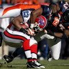 DENVER - DECEMBER 21:  Running back Marshawn Lynch #23 of the Buffalo Bills is tackled by Jamie Winborn #51 and Dewayne Robertson #63 of the Denver Broncos during NFL action at Invesco Field at Mile High on December 21, 2008 in Denver, Colorado. The Bills