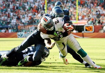MIAMI - NOVEMBER 09:  Running back Ronnie Brown #23 of the Miami Dolphins scores a touchdown in the fourth quarter as he is brought down by linebacker Julian Peterson #98 of the Seattle Seahawks at Dolphin Stadium on November 9, 2008 in Miami, Florida. Th