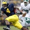 ANN ARBOR, MI - OCTOBER 25:  Brandon Minor #4 of the Michigan Wolverines tries to get around the tackle of Brandon Long #47 of the Michigan State Spartans during a third quarter run on October 25, 2008 at Michigan Stadium in Ann Arbor, Michigan. Michigan 