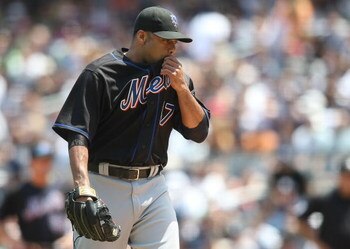 NEW YORK - JUNE 14: Johan Santana #57 of the New York Mets wipes sweat from his face against the New York Yankees on June 14, 2009 at Yankee Stadium in the Bronx borough of New York City.  (Photo by Nick Laham/Getty Images)