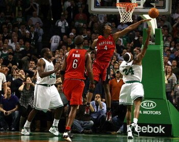 BOSTON - NOVEMBER 10:  Paul Pierce #34 of the Boston Celtics makes the shot despite the best effort of Chris Bosh #4 of the Toronto Raptors on November 10,  2008 at TD Banknorth Garden in Boston, Massachusetts. Kendrick Perkins of the Celtics and Jermaine