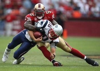 SAN FRANCISCO - OCTOBER 05:  Matt Cassel #16 of the New England Patriots is tackled by Patrick Willis #52 of the San Francisco 49ers during an NFL game on October 5, 2008 at Candlestick Park in San Francisco, California.  (Photo by Jed Jacobsohn/Getty Ima