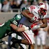 EAST LANSING, MI - NOVEMBER 01:  John Clay #32 of the Wisconsin Badgers tries for extra yards during a third quarter run in front of Adam Decker #55 of the Michigan State Spartans on November 1, 2008 at Spartan Stadium in East Lansing, Michigan. Michigan 