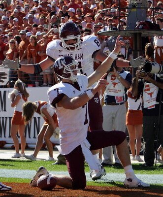 AUSTIN, TX - NOVEMBER 24:  Quarterback Stephen McGee #7 of the Texas A&M Aggies celebrates his touchdown with Joey Thomas #81 during a game against the Texas Longhorns at Darrell K Royal-Texas Memorial Stadium November 24, 2006 in Austin, Texas. The Aggie